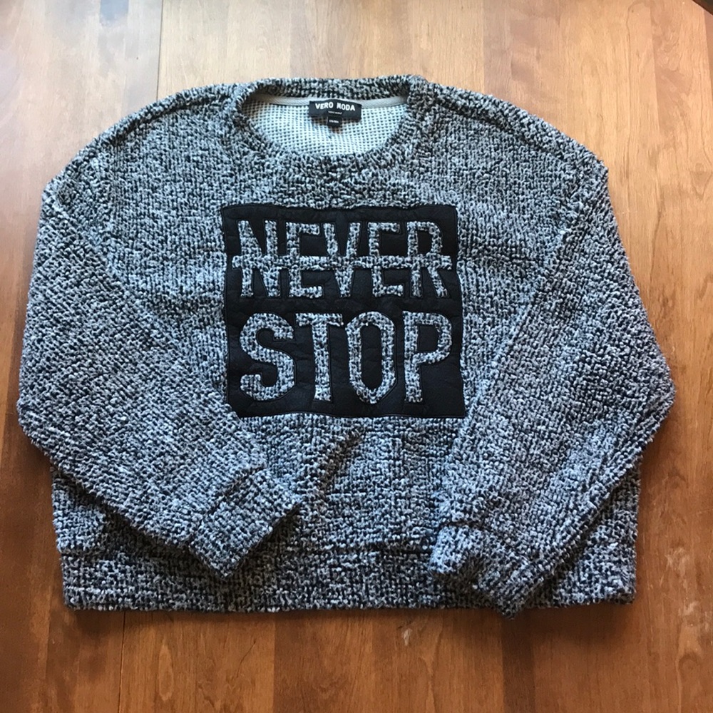 Gray, soft sweater with the text “never stop”